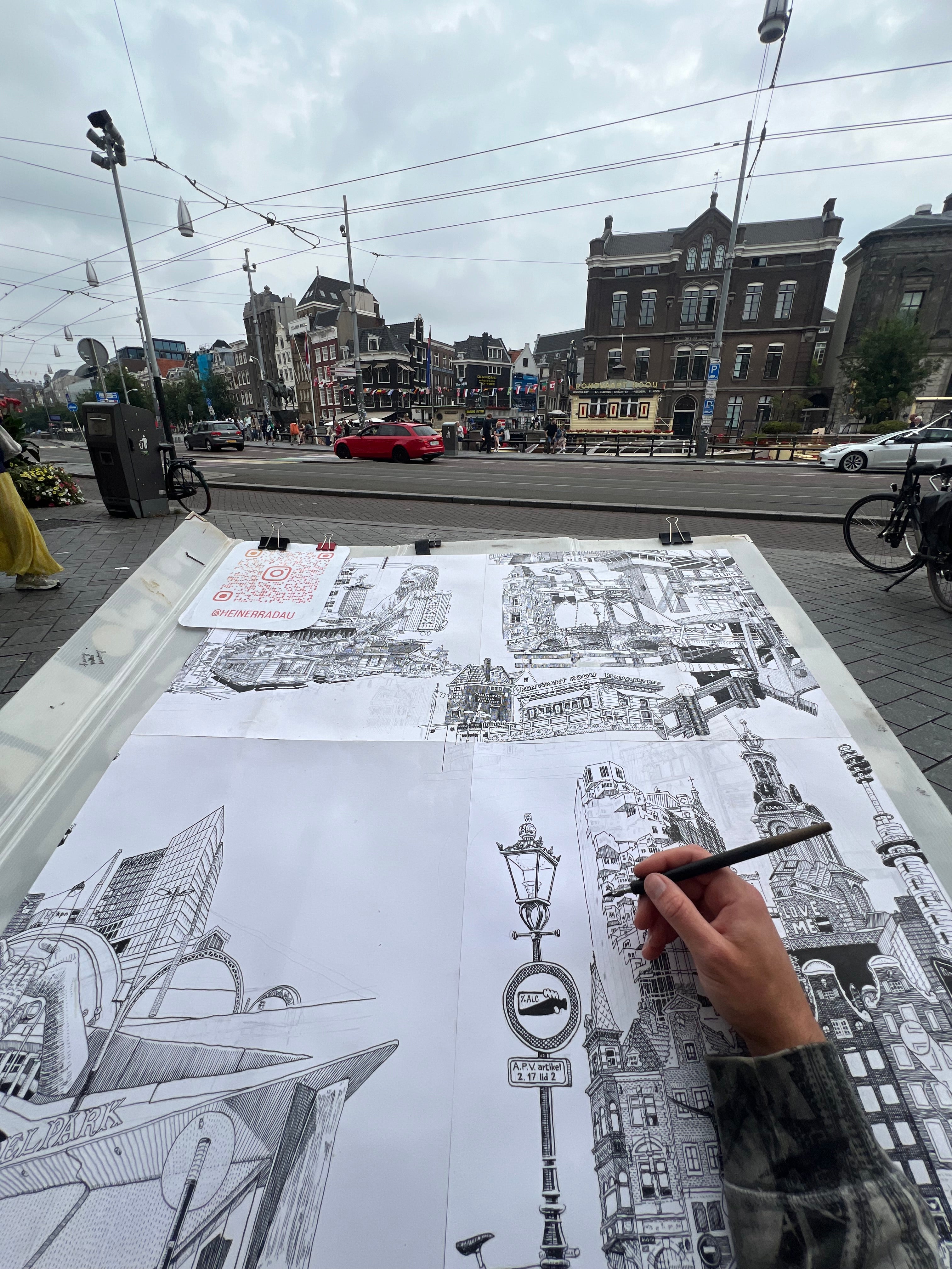 artist drawing live on the streets of amsterdam, using ink and fountain pen, handdrawn city black and white