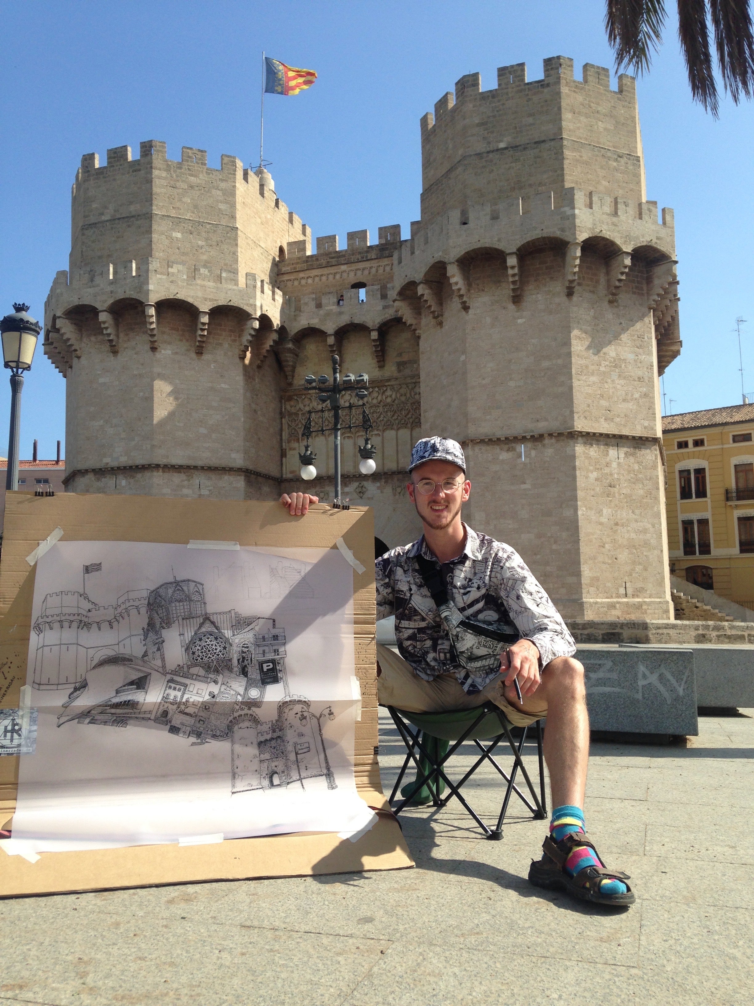 artist showing his art at a gate Valencia, using ink and fountain pen, streetart, handdrawn valencia, black and white, valencia artwork souvenir