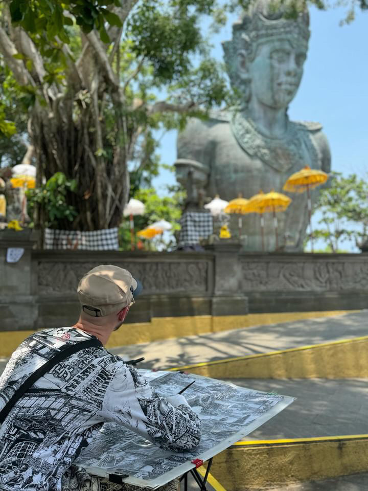 the artist is drawing Plaza Garuda - GWK Cultural Park statue in Bali, using ink and fountain pen, a handdrawn bali black and white balinese artwork or souvenir