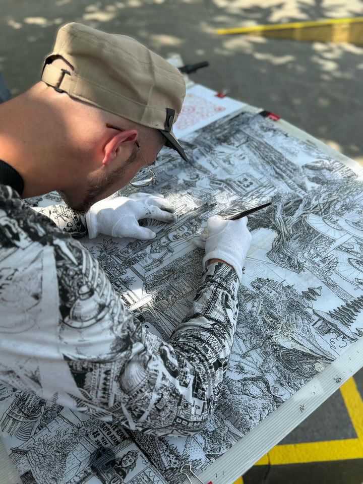 Artist drawing in Bali using ink and fountain pen, creating a detailed black and white hand-drawn sketch of Bali’s landscape, perfect as a Bali artwork souvenir